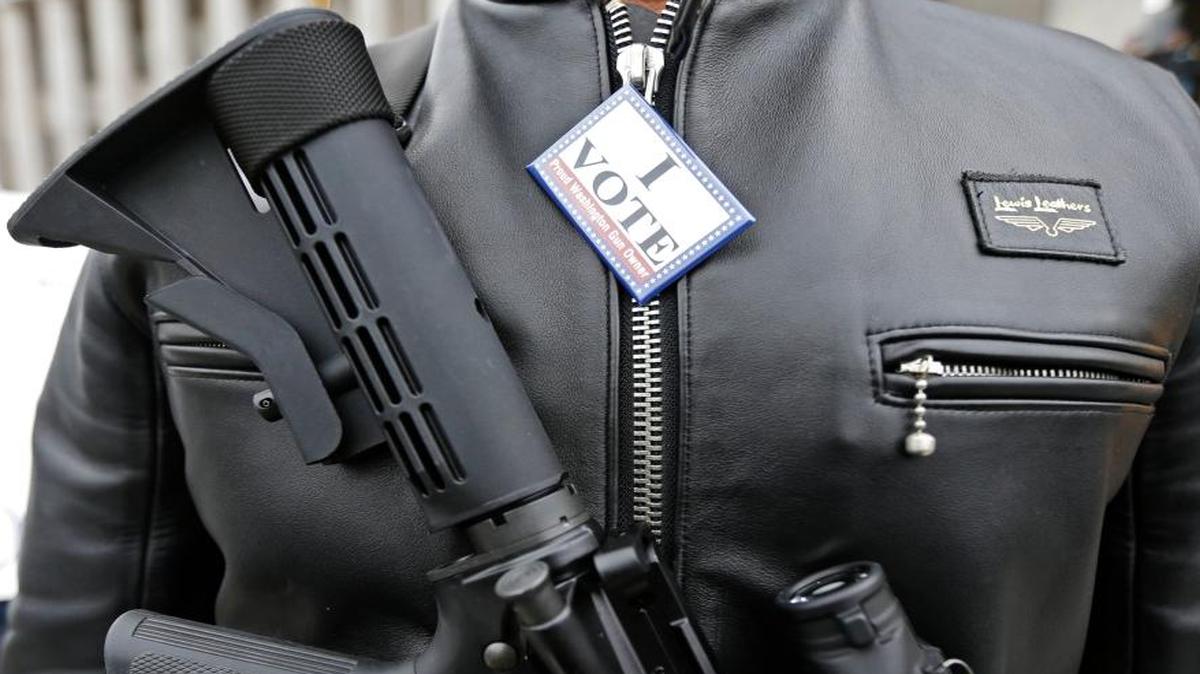 Mark Ramirez of Bainbridge Island, Wash., wears his Colt M4 gun and a button that reads “I Vote — Proud Washington Gun Owner,” during a gun-rights rally at the Capitol in Olympia, Wash., on Jan. 15, 2015.