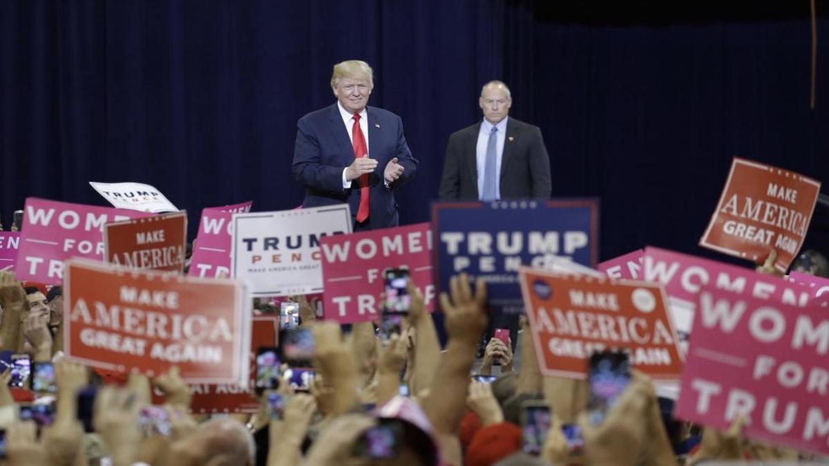 Republican presidential candidate Donald Trump, center, takes the stage at a campaign rally Saturday, Oct. 29, 2016, in Phoenix.
