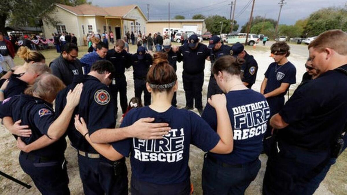 First responders join in prayer following a Veterans Day event, Saturday, Nov. 11, 2017, near the Sutherland Springs First Baptist Church, in Sutherland Springs, Texas. A man opened fire inside the church in the small South Texas community on Sunday, killing more than two dozen.