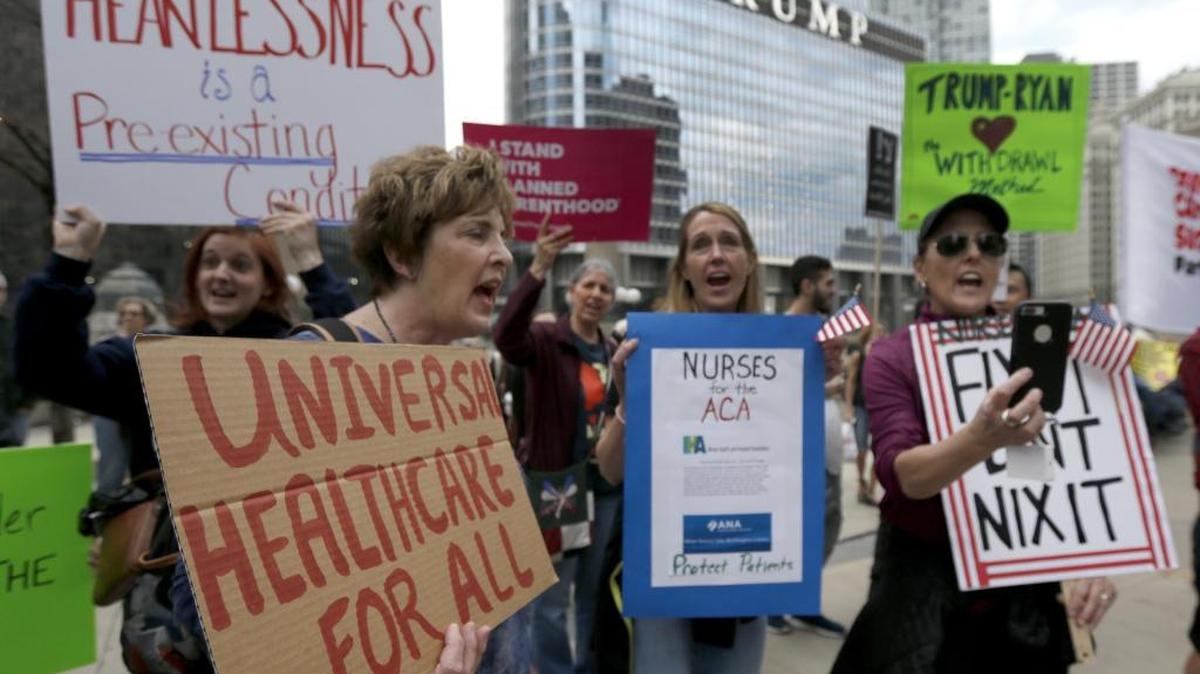 Protesters gather across the Chicago River from Trump Tower to rally against the repeal of the Affordable Care Act Friday, March 24, 2017, in Chicago.