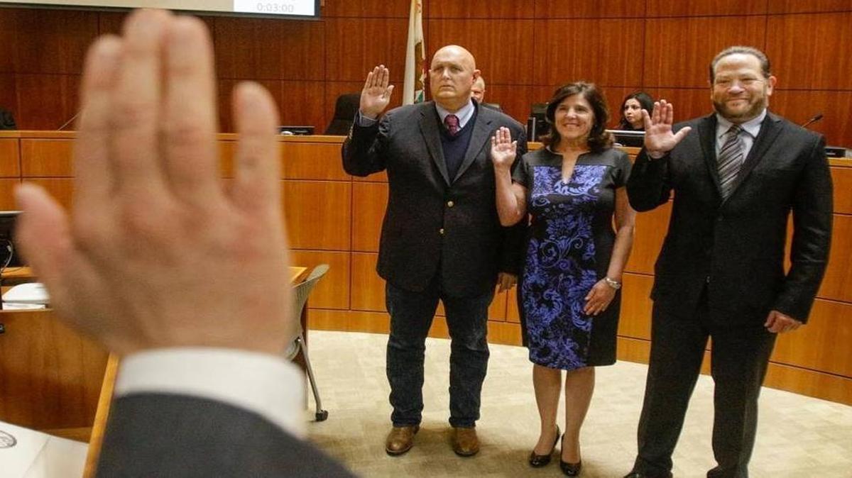 San Luis Obispo County Clerk-Recorder Tommy Gong administers the oath of office to San Luis Obispo County Supervisors, from left, John Peschong, Debbie Arnold and Adam Hill in January 2017.