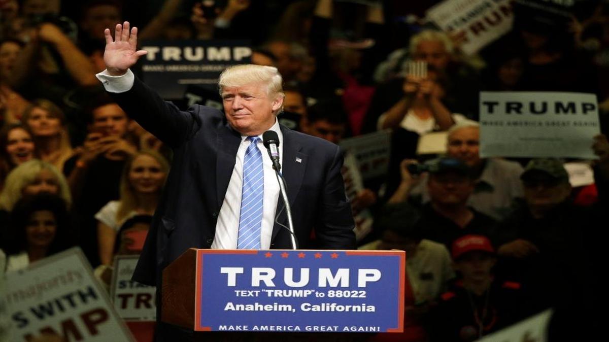 Republican presidential candidate Donald Trump waves toward the crowd after speaking at a rally at the Anaheim Convention Center on May 26.
