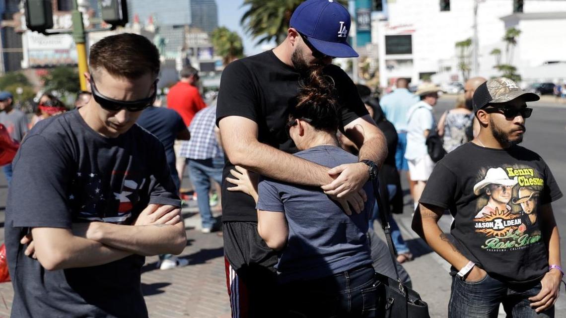 Reed Broschart, center, hugs his girlfriend Aria James on the Las Vegas Strip in the aftermath of a mass shooting at a concert Monday, Oct. 2, 2017, in Las Vegas. The couple, both of Ventura, Calif., attended the concert.