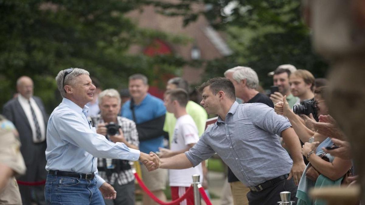 Former New Mexico governor, Libertarian presidential candidate Gary Johnson shakes hands as he arrives for a campaign rally Thursday, Aug. 25, 2016, in Concord, N.H.
