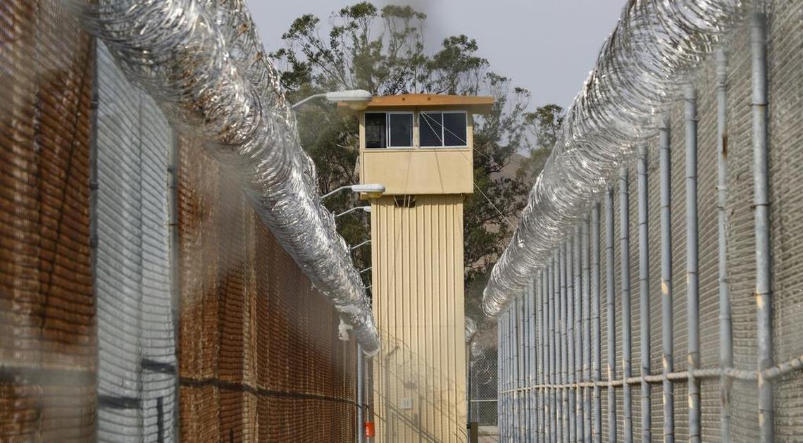 A tower overlooks cyclone fence topped with razor wire at the California Men’s Colony’s West Facility in San Luis Obispo.