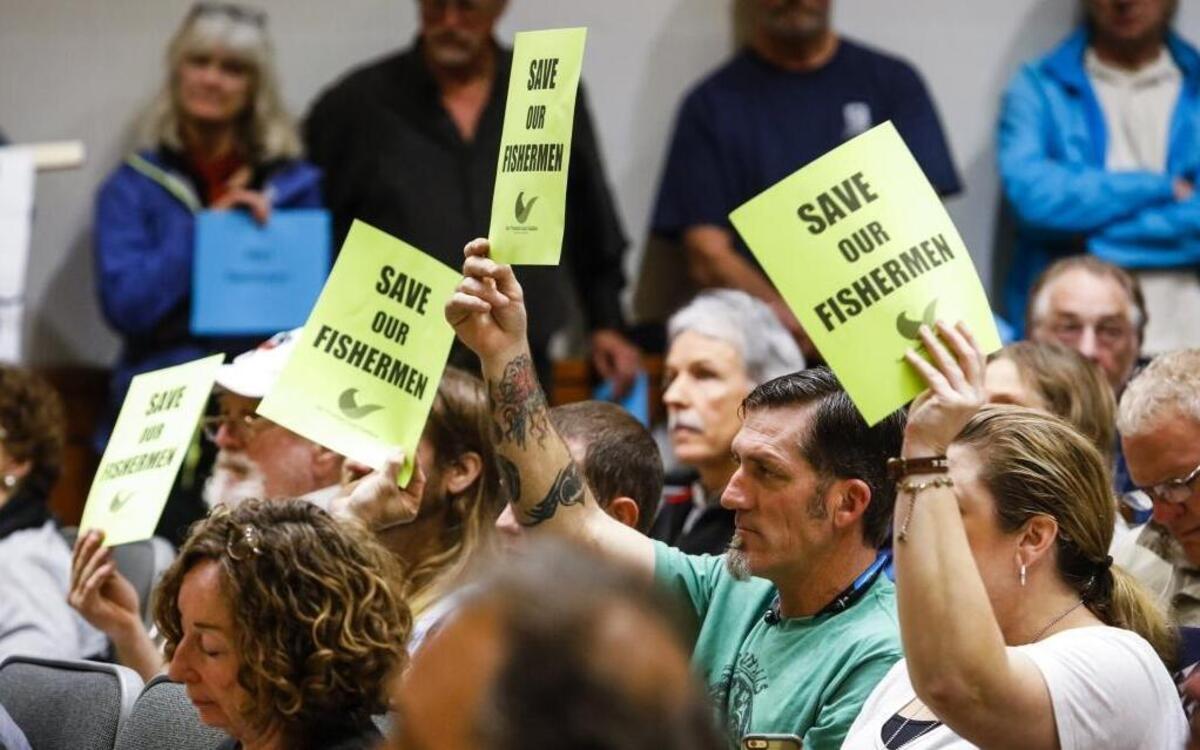 Opponents of the Chumash Heritage National Marine Sanctuary holds signs during the Board of Supervisors meeting Tuesday, Feb. 7, 2017.