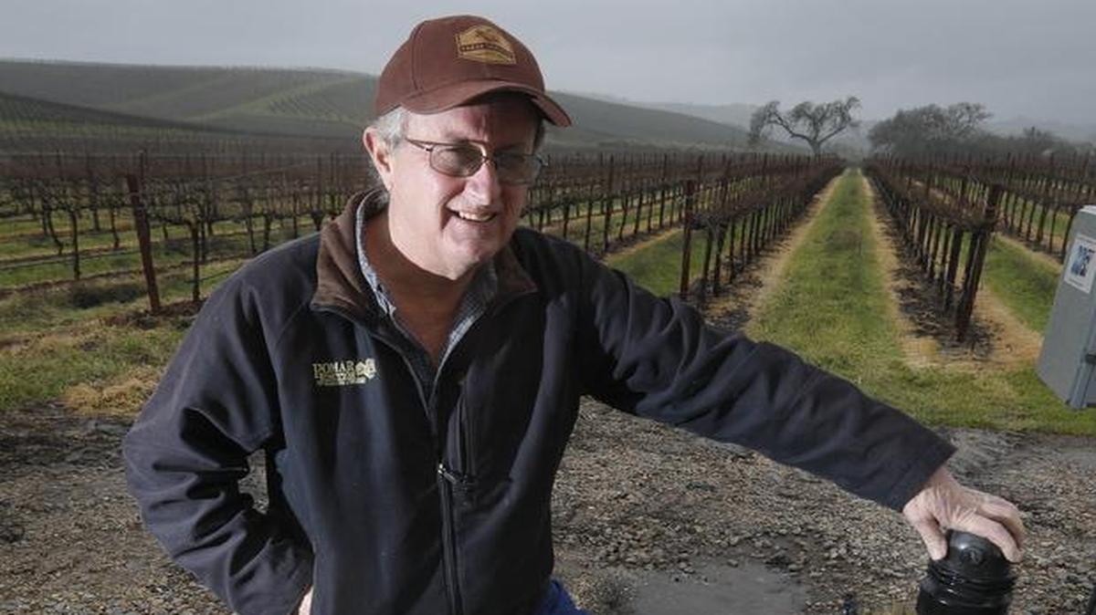 Dana Merrill owns Pomar Junction Vineyard & Winery and is helping to form the Estrella-El Pomar-Creston water district in the North County. He stands next to one of the wells that irrigates his property in February 2017.