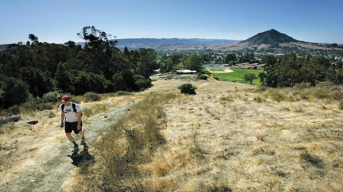 James Henderson takes an afternoon hike up the trail near Lizzie Street in San Luis Obispo in 2005.