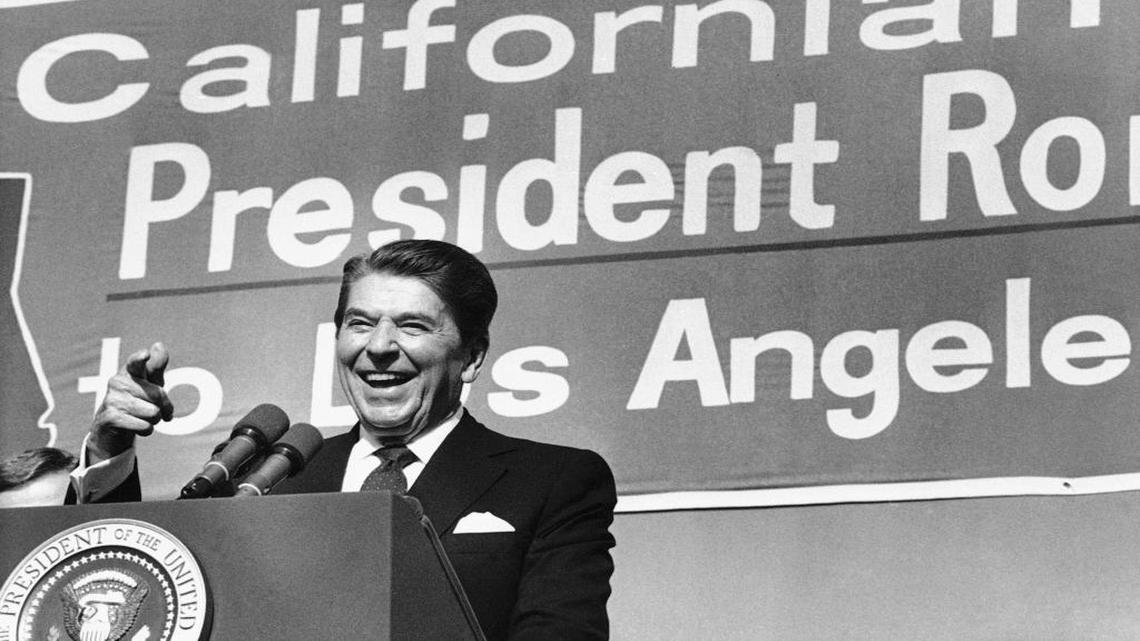 President Ronald Reagan points toward the crowd as he speaks during a rally at Pierce College in the Woodland Hills area of Los Angeles on Nov. 5, 1984.