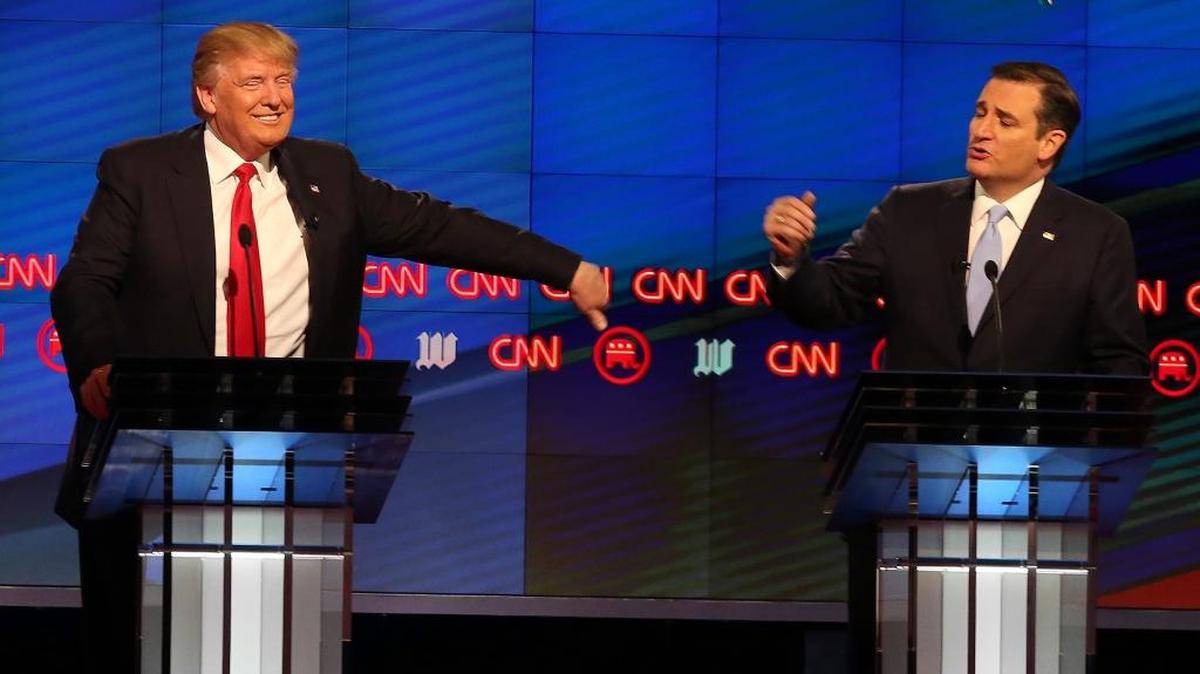 Republican presidential candidate Donald Trump, reacts as Republican presidential candidate Sen. Ted Cruz, R-Texas,rebukes a comment made by Trump during the Republican presidential debate sponsored by CNN, Salem Media Group and the Washington Times at the University of Miami, Thursday, March 10, 2016, in Coral Gables, Fla.