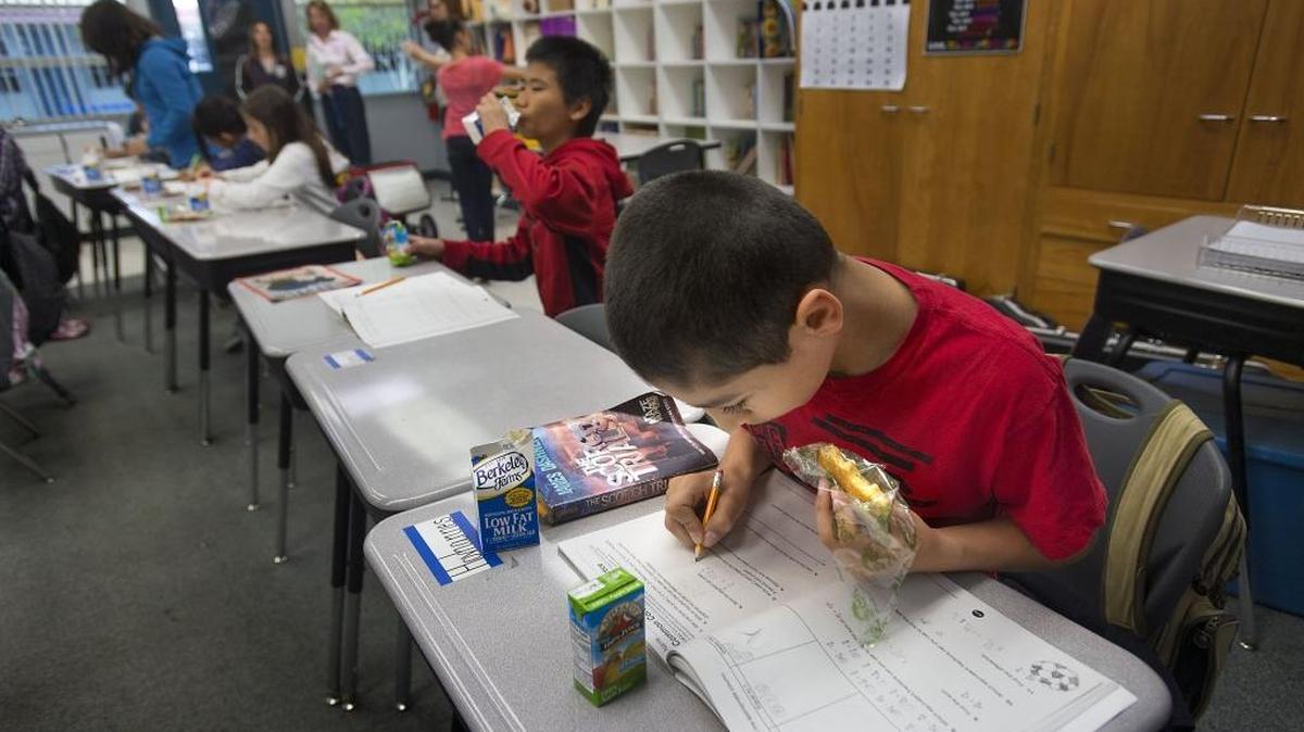 Hovhannes Muradyan, 10, eats breakfast while doing schoolwork last year at his desk at White Rock Elementary in Rancho Cordova. Doubts have been raised about accountability for state education spending.