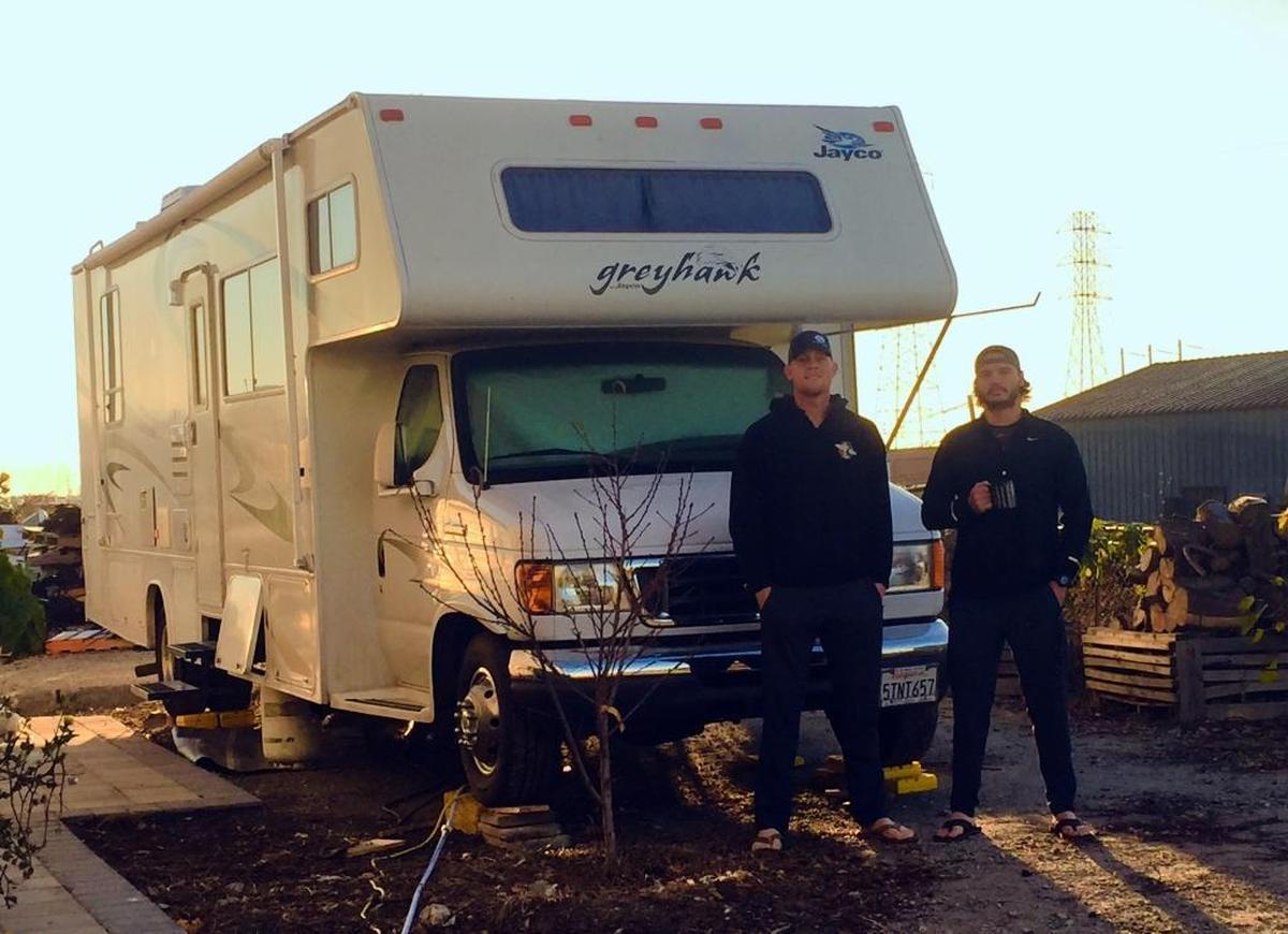 SLO High and Cuesta College graduate Max Duval (left) stands with Kevin Mixon in front of their 25-foot Jayco motorhome parked outside a Salinas business. The two friends are living in the RV while they prepare for the upcoming minor league baseball season.