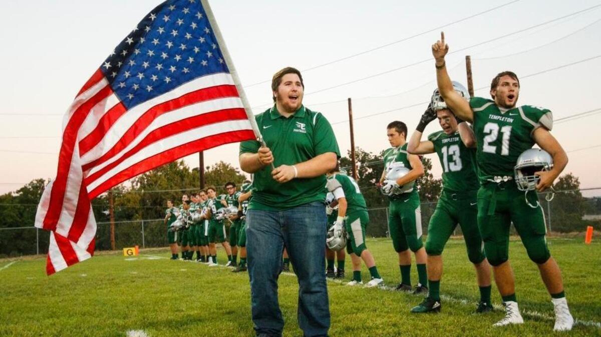 Isaac Lindsey holds the flag at Templeton High School’s season-opening football game against Strathmore on Sept. 2.