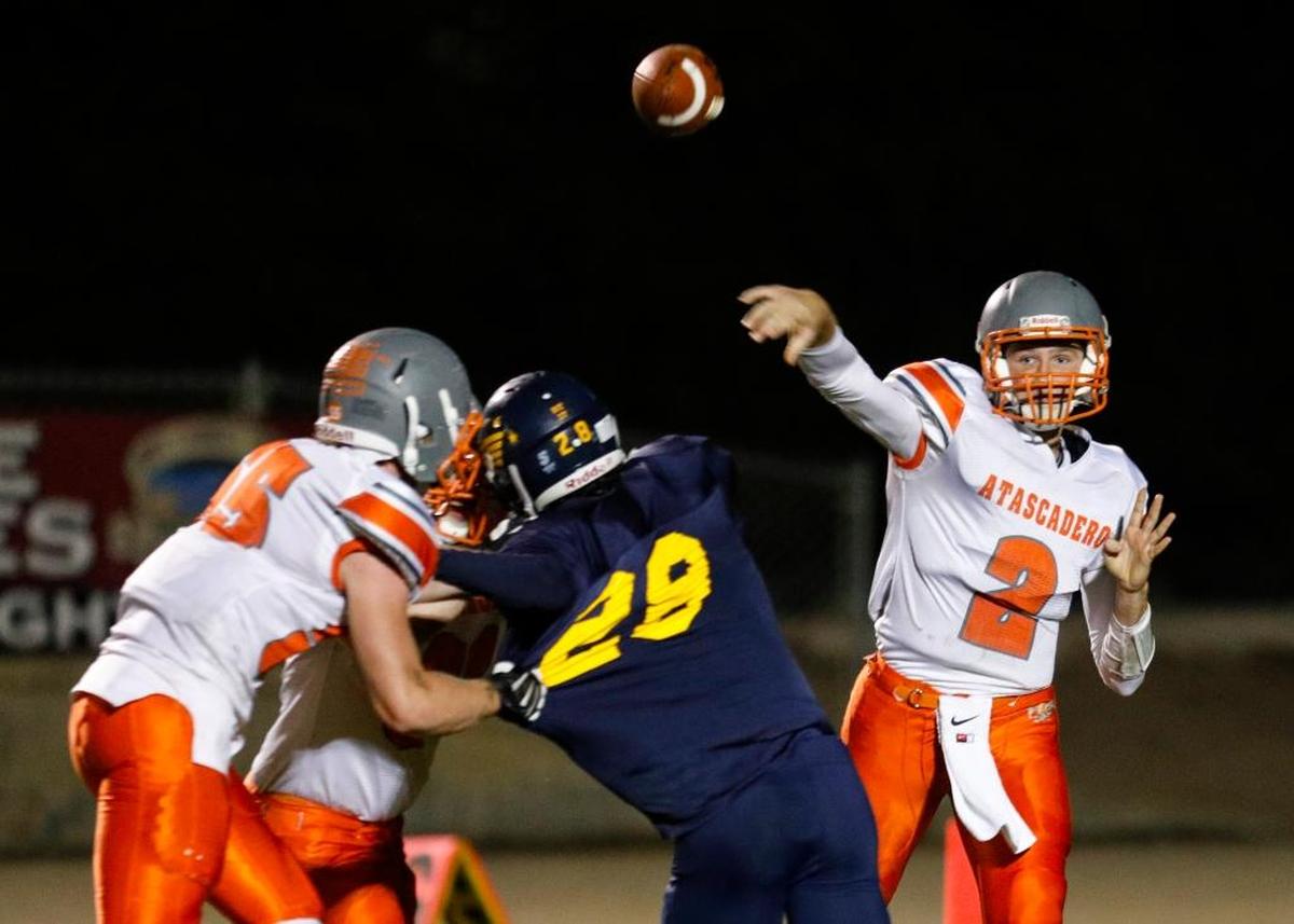Arroyo Grande hosted Atascadero in high school football. Tyler Valenti rushes while Carson Rinkenberger throws. John-Connor Ruggiero is one of the Atascadero linemen.