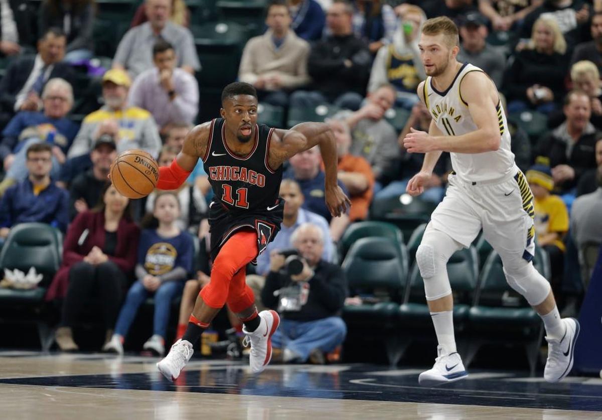 Chicago Bulls guard David Nwaba (11) heads up court in front of Indiana Pacers center Domantas Sabonis (11) during the first half of an NBA basketball game in Indianapolis, Wednesday, Dec. 6, 2017.