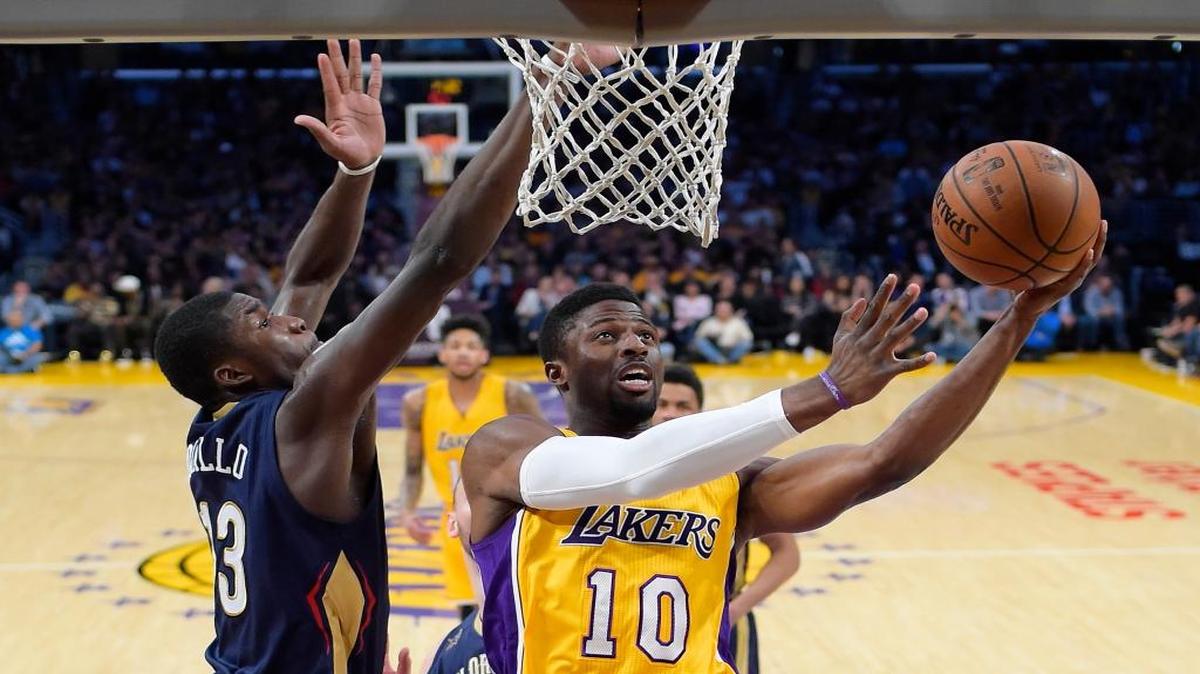 Cal Poly graduate David Nwaba (10) shoots as New Orleans forward Cheick Diallo defends during the first half of an NBA game last season.