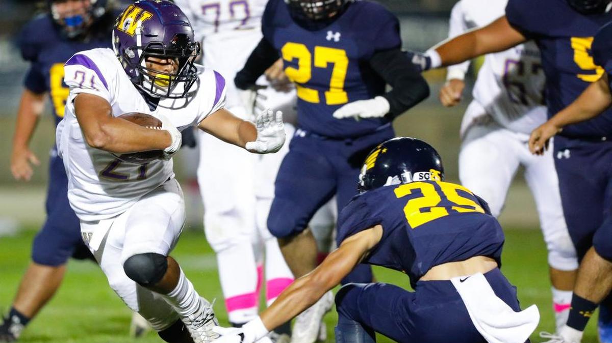 Arroyo Grande High School’s Mason Thompson tried to take down Righetti running back Adan Solis in a Mountain League game Friday night.