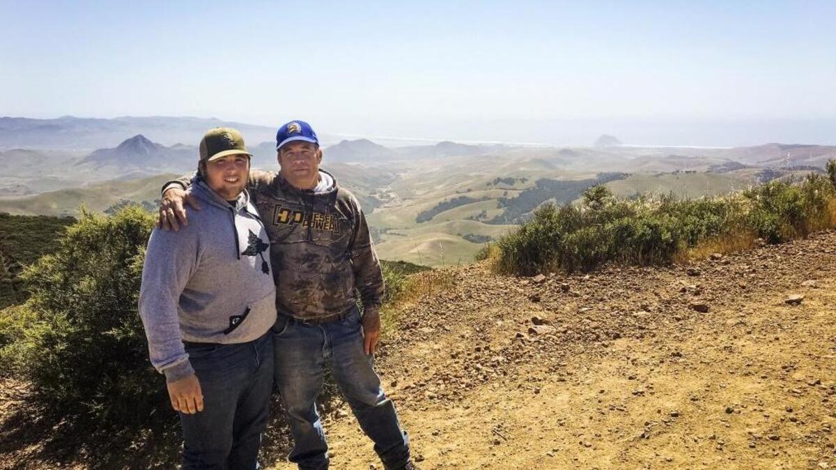 Isaac (left) and Michael Lindsey stand on the Cerro Alto summit overlooking Morro Bay.