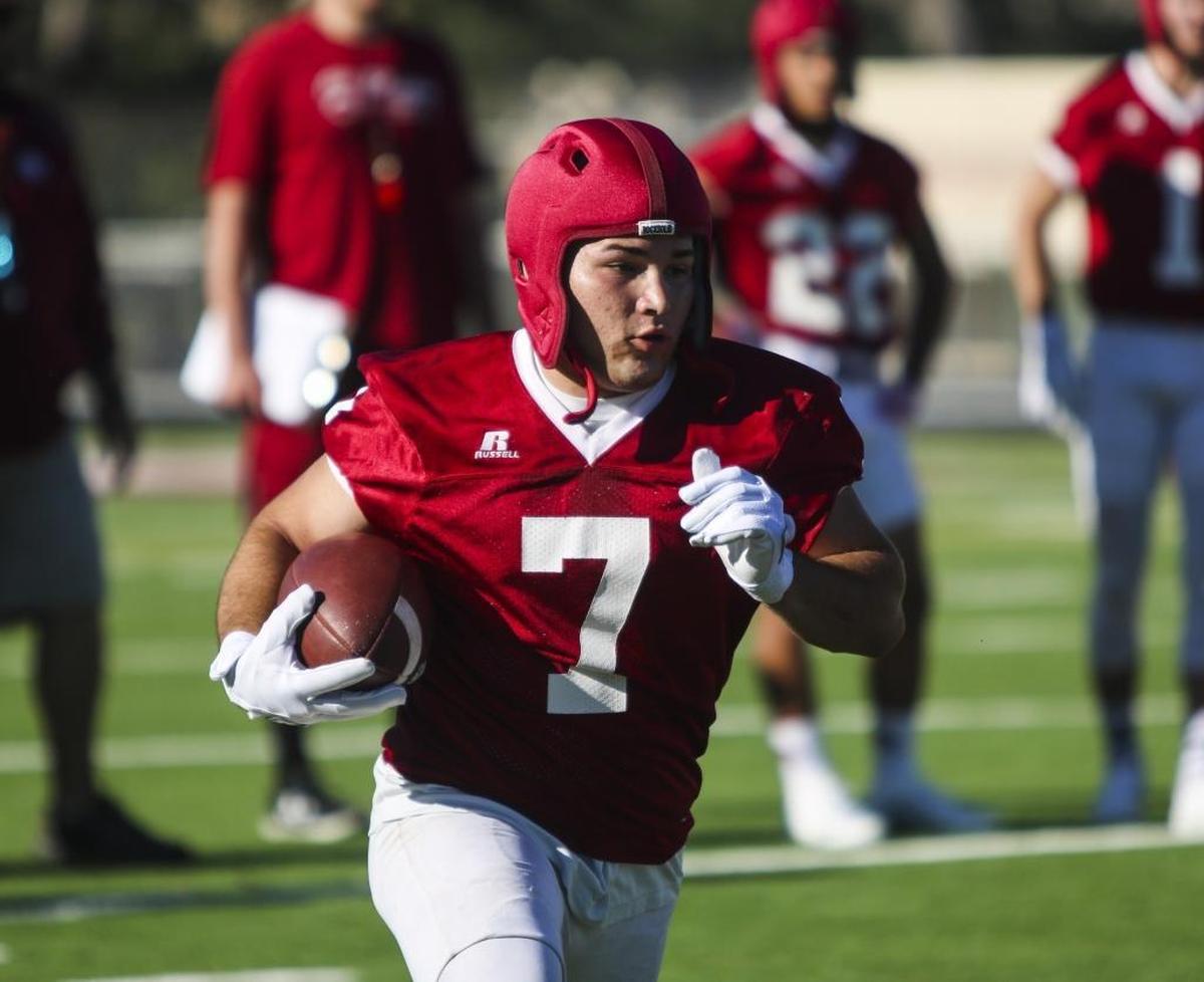 Paso Robles High junior Nathan Garcia sprints on the new artificial turf field at Flamson Middle School's War Memorial Stadium during the spring football showcase.