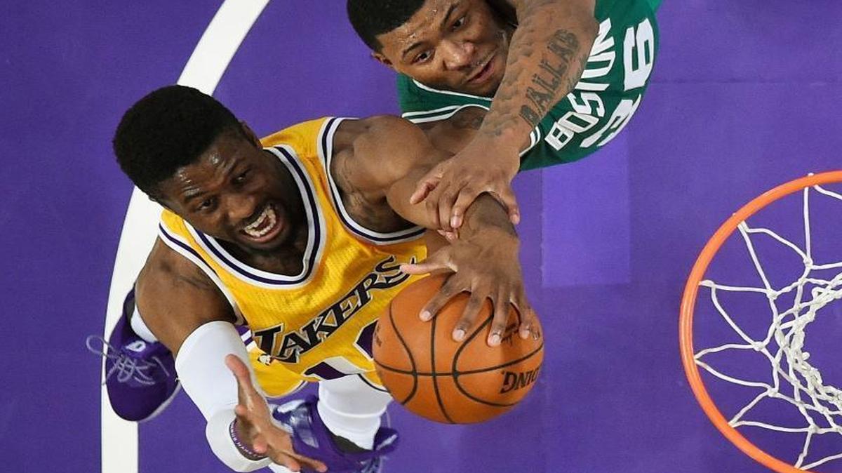 Los Angeles Lakers guard David Nwaba, left, and Boston Celtics guard Marcus Smart reach for a rebound during the second half of game March 3 in Los Angeles.
