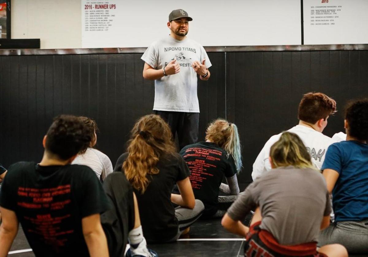 Nipomo High School girls wrestling coach Justin Magdaleno talks to his team at the end of a practice.