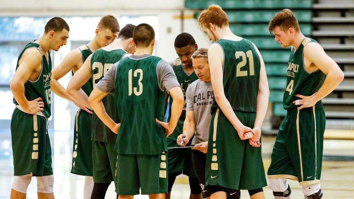 The Cal Poly men's basketball coach Joe Callero works with his team during a practice last year.