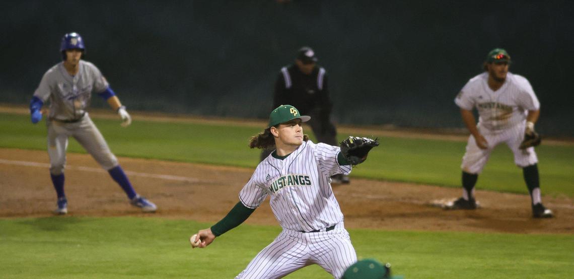 Jason Franks pitches with a runner, Jason Willow on first. Joe Yorke holds the runner on. Cal Poly lost to UCSB 7-10 in an 11 inning game April 29, 2022. Franks was drafted by the Atlanta Braves.