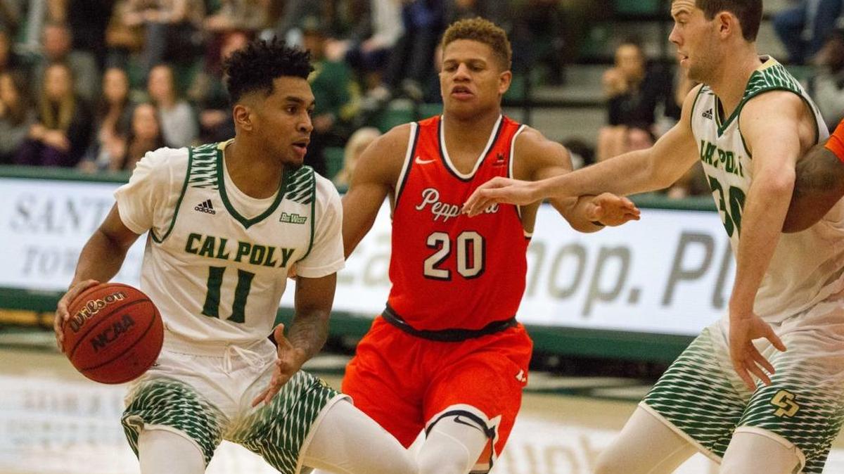 Cal Poly’s Marcellus Garrick (left) drives on Pepperdine's Kameron Edwards with Hank Hollingsworth looking on. Garrick scored a career-high 20 poinnts