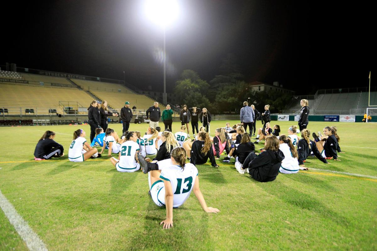 Cal Poly players wind down and listen to the coach after defeating Montana 2-1 on Thursday, Aug. 26, 2021, at Alex G. Spanos Stadium in San Luis Obispo.