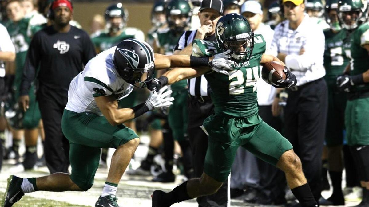 Cal Poly’s Kori Garcia is pushed out of bounds by a Portland State defender during the Mustangs’ loss to the Vikings on Saturday night at Alex G. Spanos Stadium.