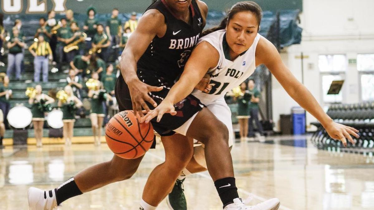 Cal Poly's Lynn Leaupepe battles Santa Clara's Taylor Berry for the ball during Friday's women basketball game.