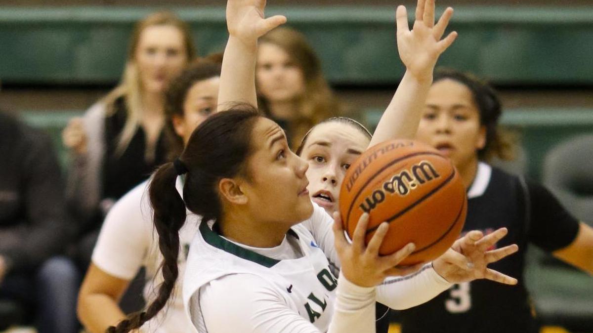 Cal Poly’s Lynn Leaupepe shoots over CSUN’s Katelin King during a Big West Conference women’s basketball Thursday night at Mott Athletics Center.