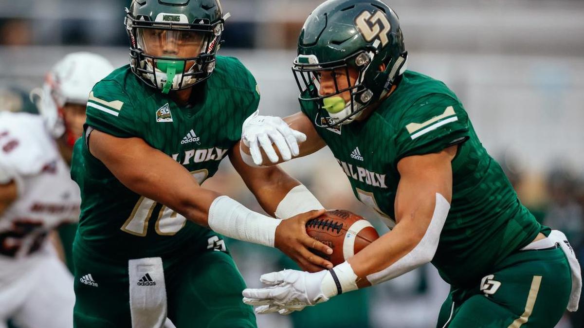 Cal Poly quarterback Kahleel Jenkins hands off to fullback Joe Protheroe in the Mustangs’ 38-24 victory Saturday over Southern Utah in the season finale for both teams. Protheroe set the school career rushing record in the win.