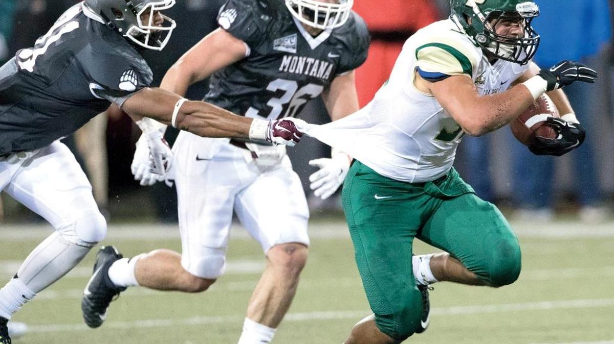 Cal Poly fullback Jared Mohamed, right, breaks away from Montana safety Justin Whitted during a game Sept. 5 in Missoula, Mont. Mohamed had 124 yards rushing in the Mustangs’ loss to Southern Utah on Saturday.