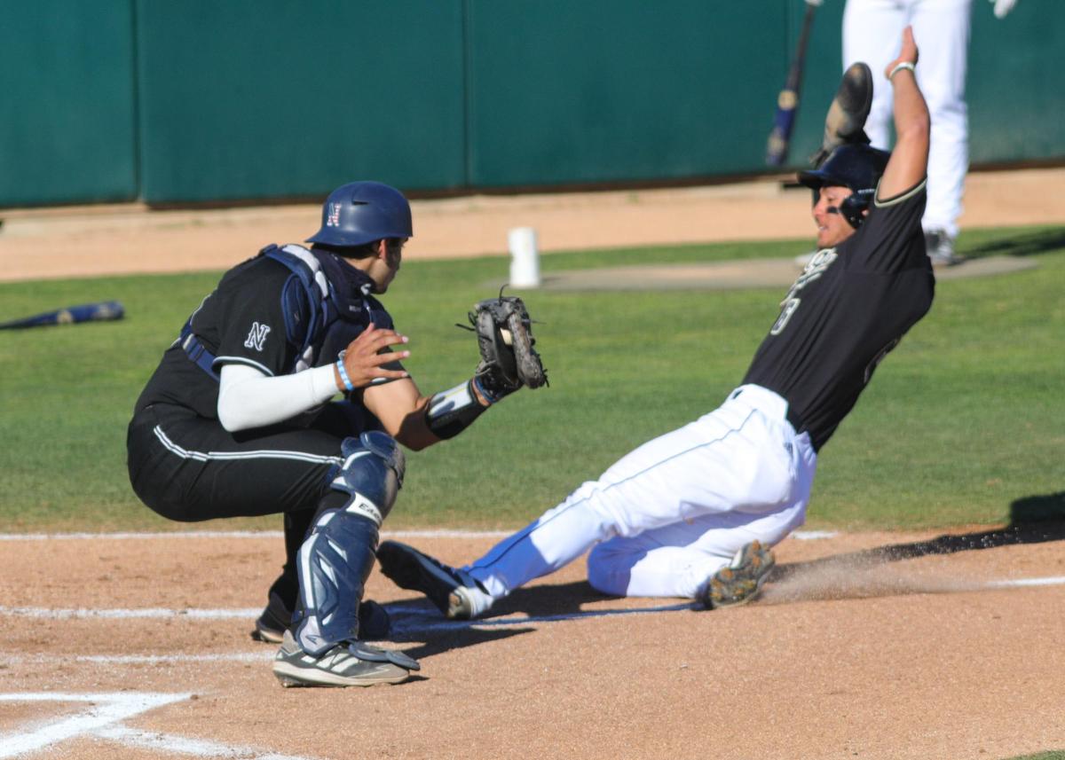 Nevada catcher Marco Valenzuela tags out Cal Poly’s Cole Cabrera at home in a game on Monday, Feb. 22, 2021.