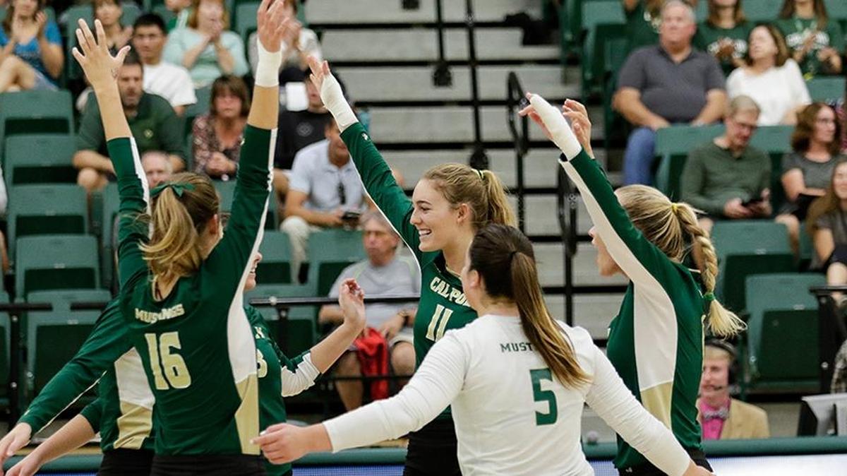 Torrey Van Winden (11), Adlee Van Winden (right), Katherine Brouker and Raeann Greisen celebrate a point in a match Sept. 23 against UC Riverside. Torrey Van Winden transferred to Cal Poly from UCLA this season to be reunited with her sister, Adlee, a combination that has led Cal Poly to a historic start this season.