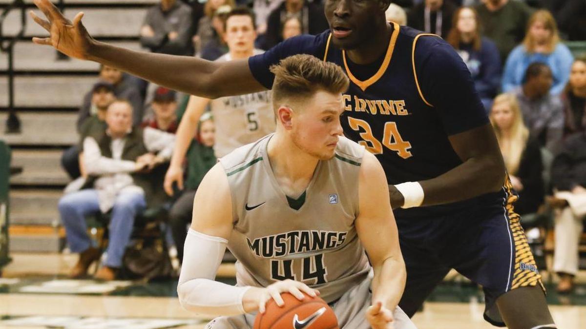 UC Irvine’s Mamadou Ndiaye defends Cal Poly’s Zach Gordon on in the low post. The Anteaters rallied to be the Mustangs, 78-72, in overtime on Wednesday night.