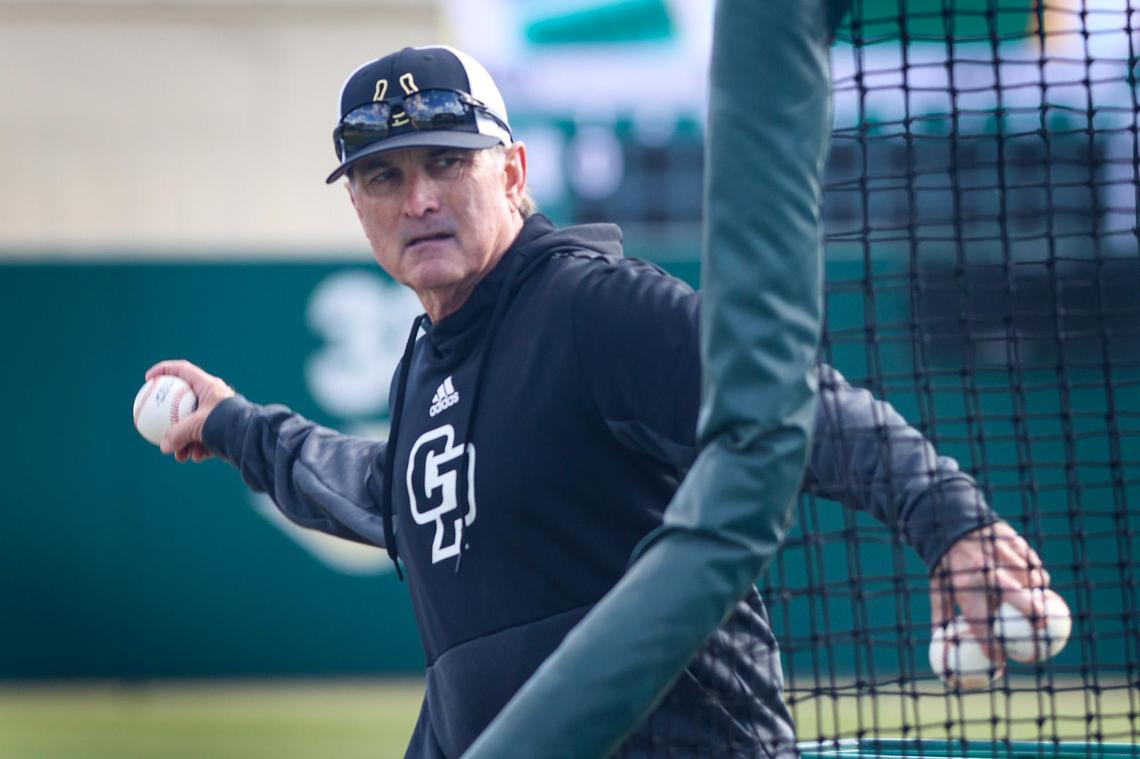 Cal Poly Coach Larry Lee pitches batting practice on Feb. 16, 2022. His son, Brooks, is a top MLB prospect.