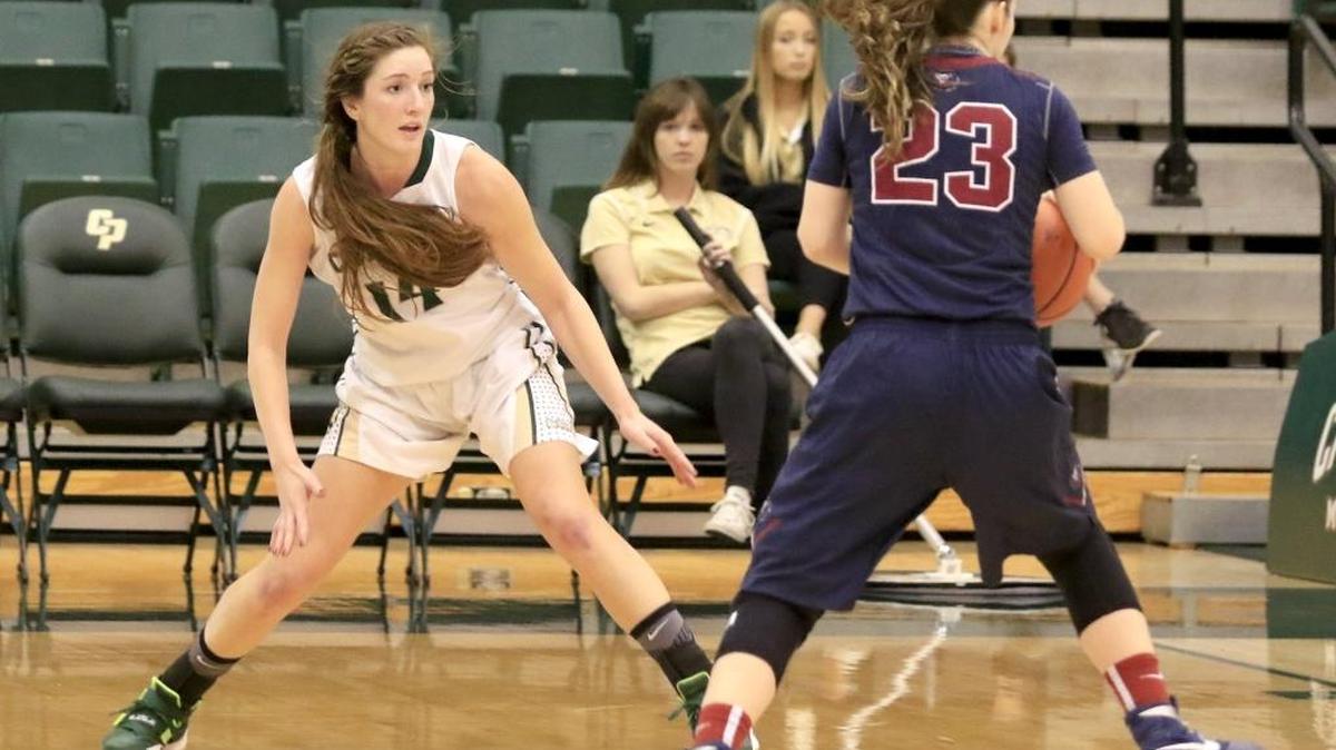 Cal Poly’s Beth Balbierz (14) guards Loyola Marymount’s Leslie Lopez-Wood (23) during the fourth quarter of the Mustangs’ win Saturday at Mott Athletics Center.