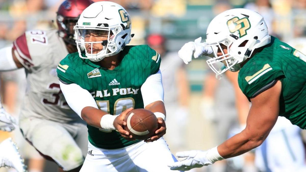 Senior quarterback Kaheel Jenkins (10) hands the ball off to fullback Joe Protheroe as Cal Poly hosts Colgate Raiders at Alex G. Spanos Stadium, Saturday, August 26, 2017.