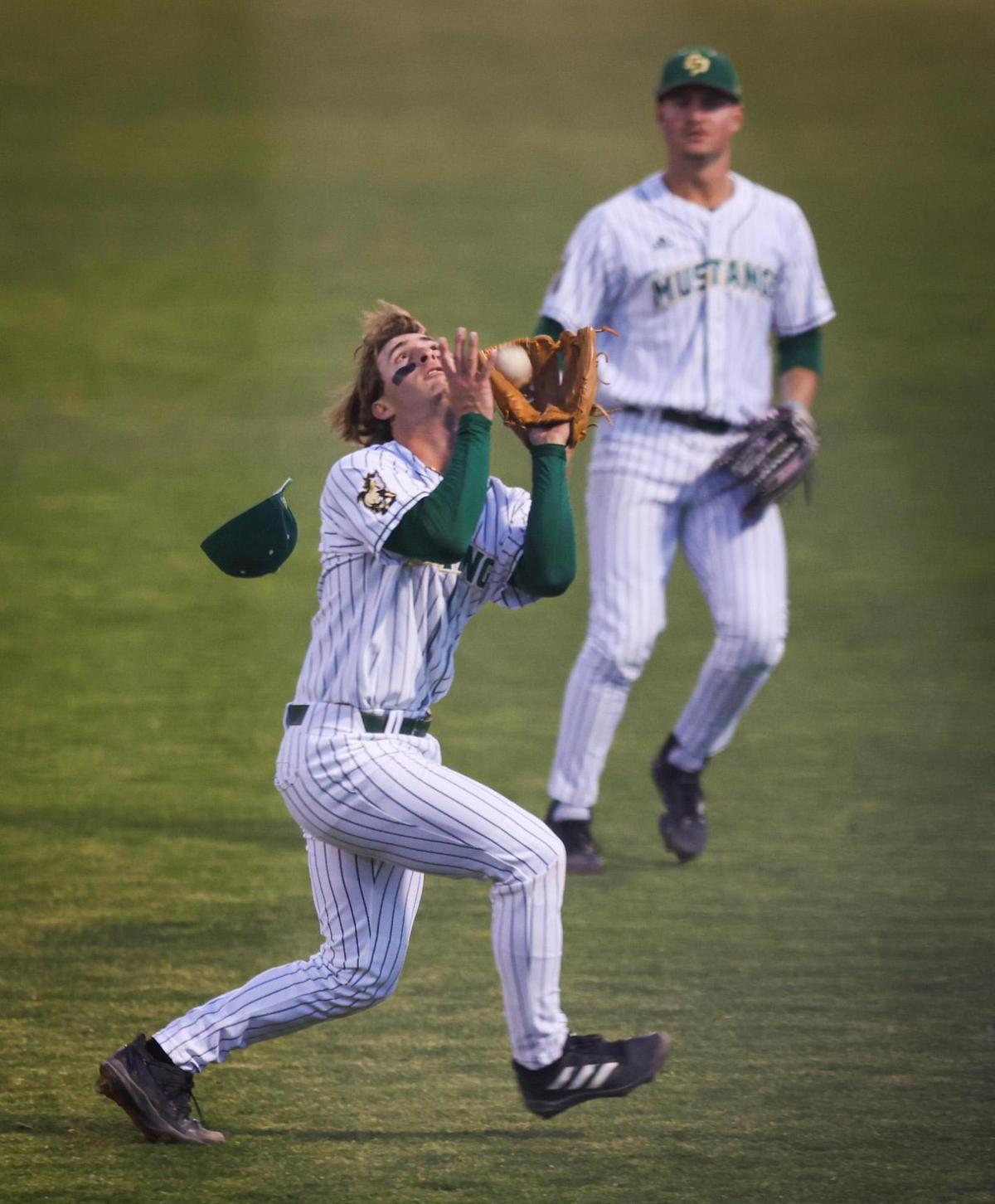 Brett Borgogno chases down a pop up in shallow right field, Matthias Haas is in background. Cal Poly comes from behind to win over CSUN 6-4 during the Big West Conference opener March, 18, 2022.