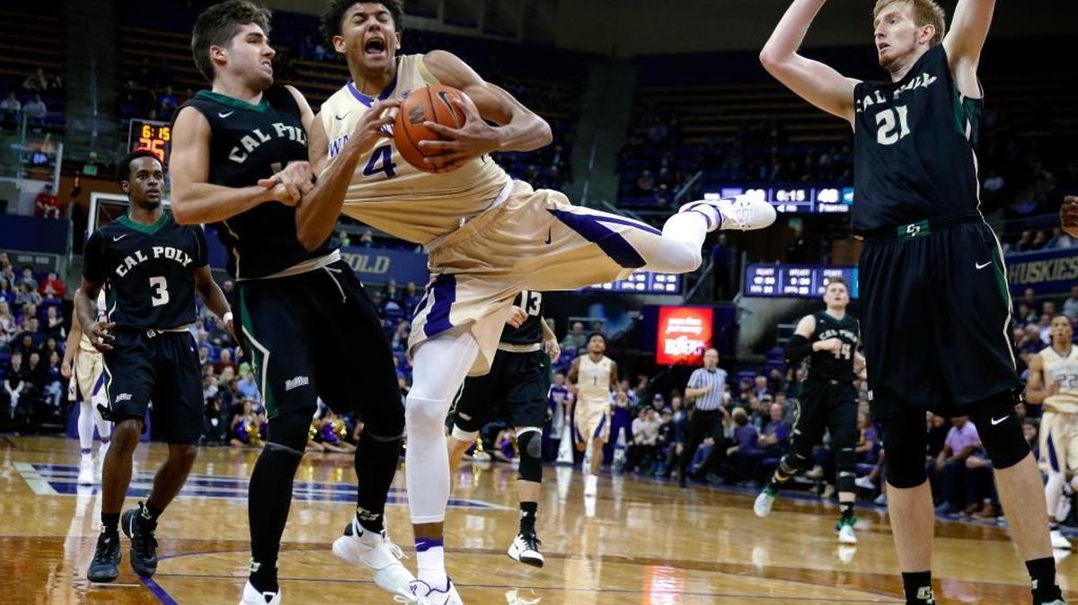 Cal Poly guard Ridge Shipley, front left, commits a flagrant foul on Washington forward Matisse Thybulle (4) during the second half of an NCAA college basketball game Tuesday in Seattle.