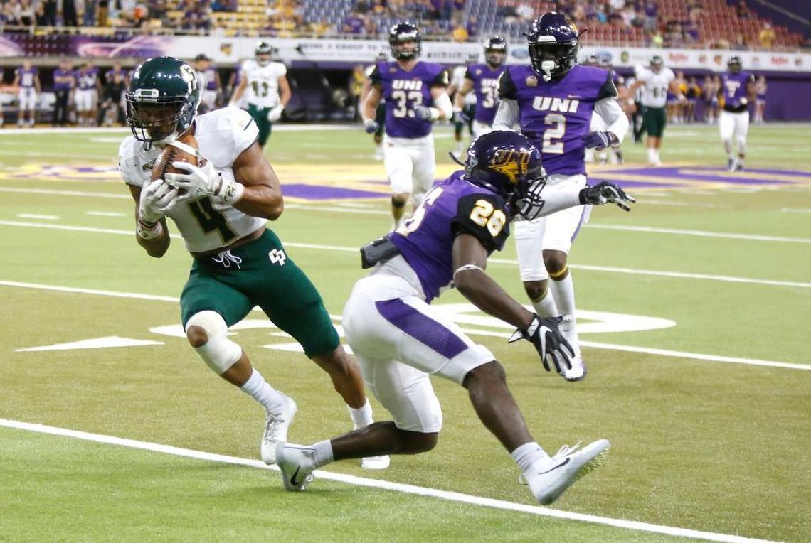 Cal Poly's Kyle Lewis, left, gets past Northern Iowa's Isaiah Nimmers, right, to score a touchdown late in the second half of an NCAA college football game Saturday, Sept. 9, 2017, in Cedar Falls, Iowa. (Matthew Putney/The Gazette via AP)