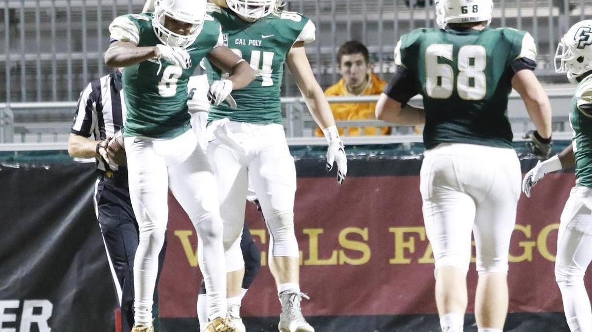 Cal Poly’s Jordan Hines, left, and Reagen Enger celebrate during the Mustangs’ 36-14 win over Sacramento State on Saturday at Alex G. Spanos Stadium.