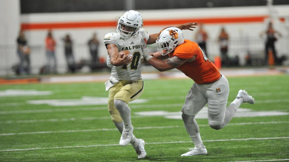 Cal Poly junior quarterback Khaleel Jenkins is shoved by an Idaho State defender during a 38-34 loss last Saturday.