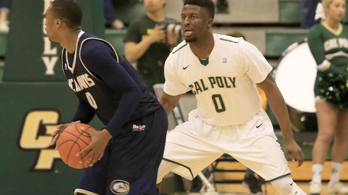 Cal Poly’s David Nwaba guards UC Davis’ Brynton Lemar during the Mustangs’ 58-53 victory Thursday night at Mott Athletics Center.