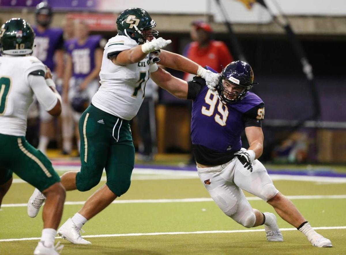 Northern Iowa’s Adam Reth, right, is blocked by Cal Poly’s Zach Shallcross during the second half of an NCAA college football game Saturday, Sept. 9, 2017, in Cedar Falls, Iowa. (Matthew Putney/The Gazette via AP)