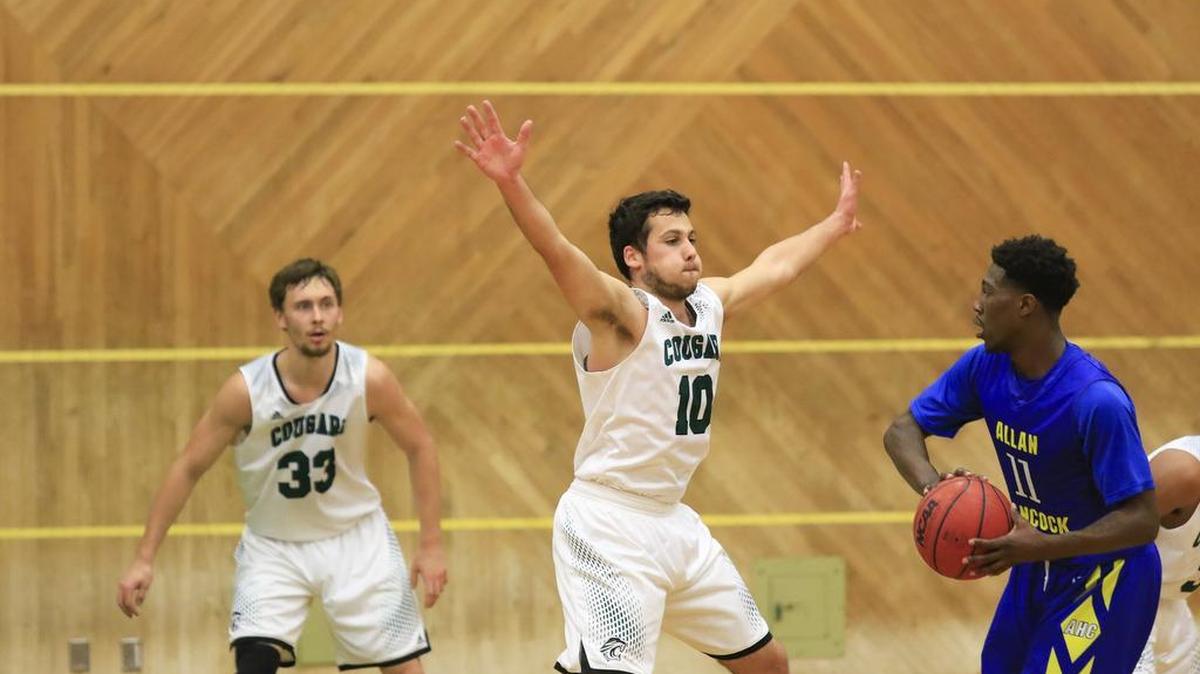 The Cuesta College men’s basketball defeated Allan Hancock 89-84 in overtime Wednesday night at Cuesta Gym. Cuesta’s Andres Aguado (10) guards Malik Rhodes (11) with assistance from Evgeniy Moiseev (33).