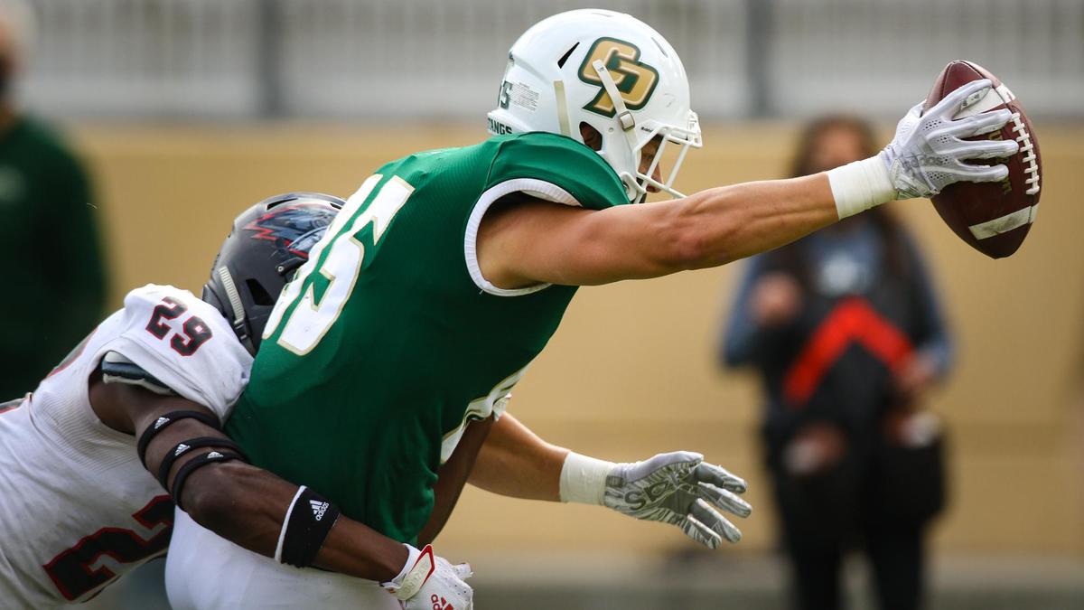 Michael Roth gets a catch across the goal line for a touchdown. Roderick Ward attempts to tackle. Cal Poly hosted Southern Utah in the first football game of the season. Alex G. Spanos stadium had no spectators due to coronavirus restrictionns Saturday March. 13, 2021.