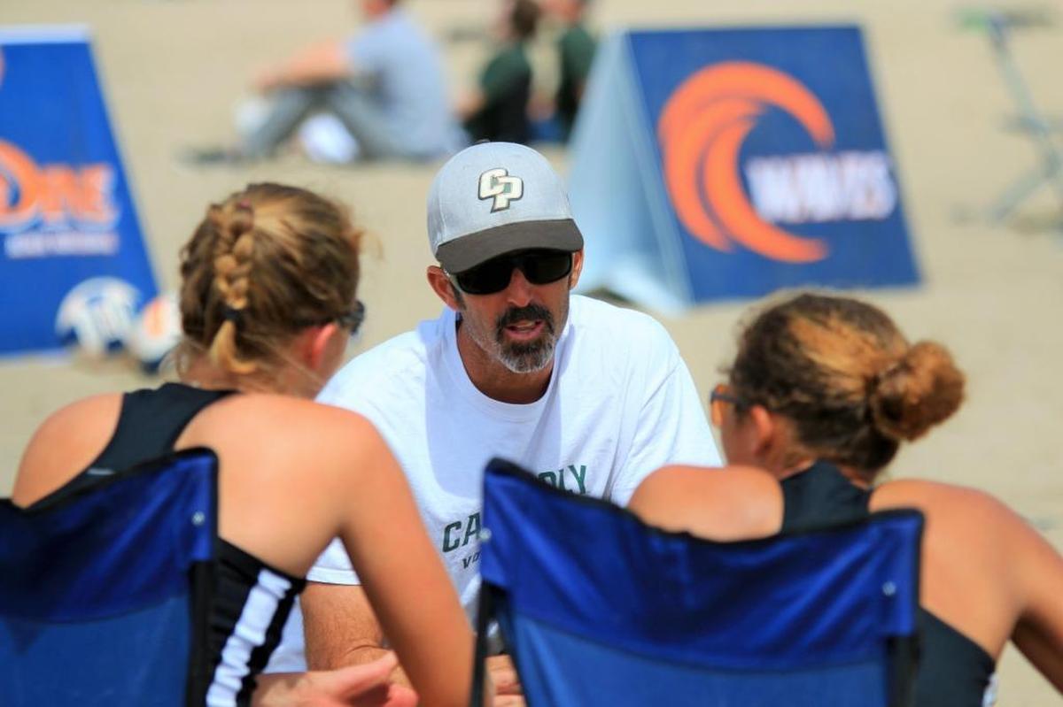 Cal Poly beach volleyball coach Todd Rogers, center, speaks to his players during a match earlier this season. The Mustangs are scheduled to host the Big West Beach Volleyball Championships on Friday and Saturday at Pismo Beach.